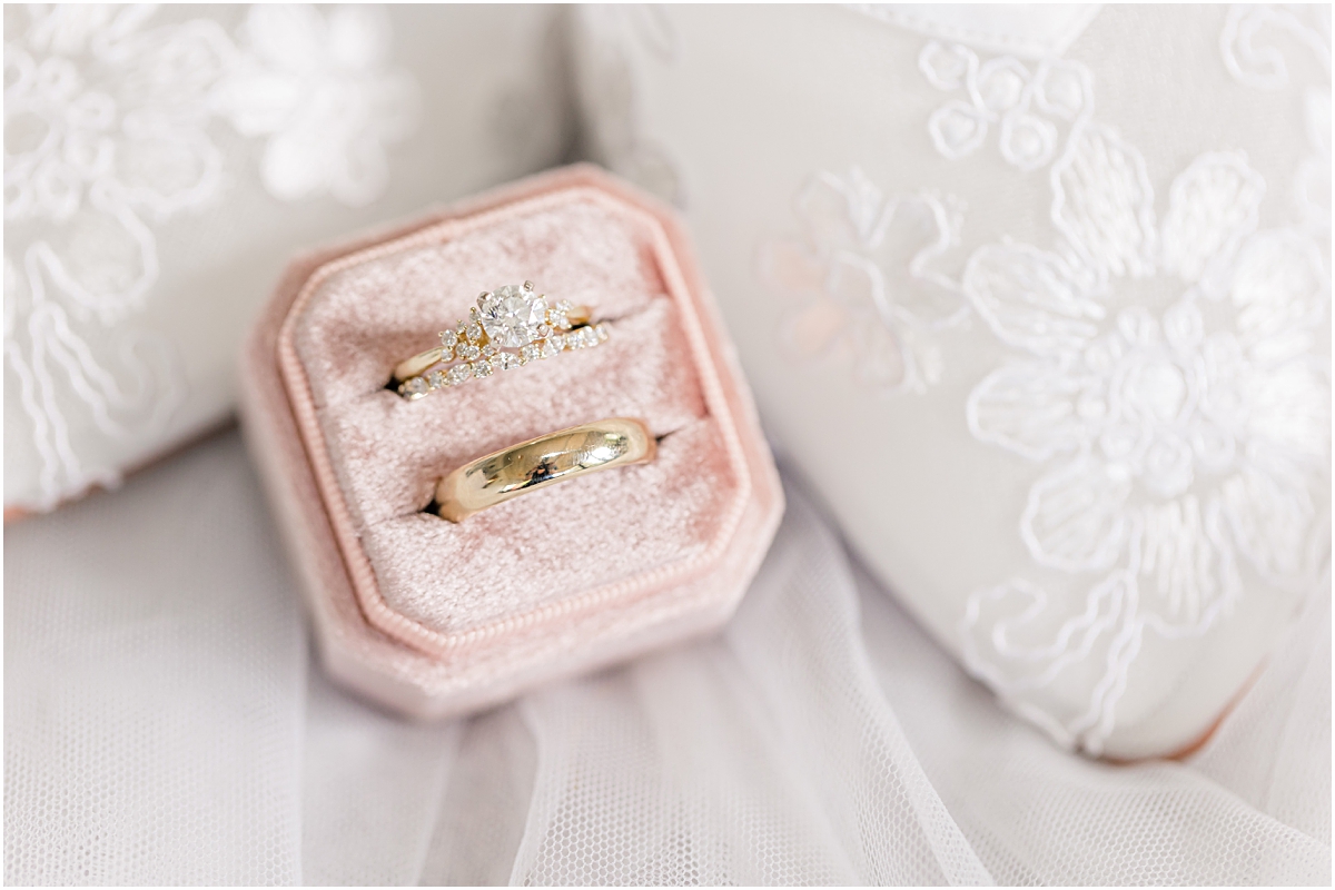 Detail photo of Grace's ring and wedding band in a pink ring box at Cleveland GA Wedding Venues