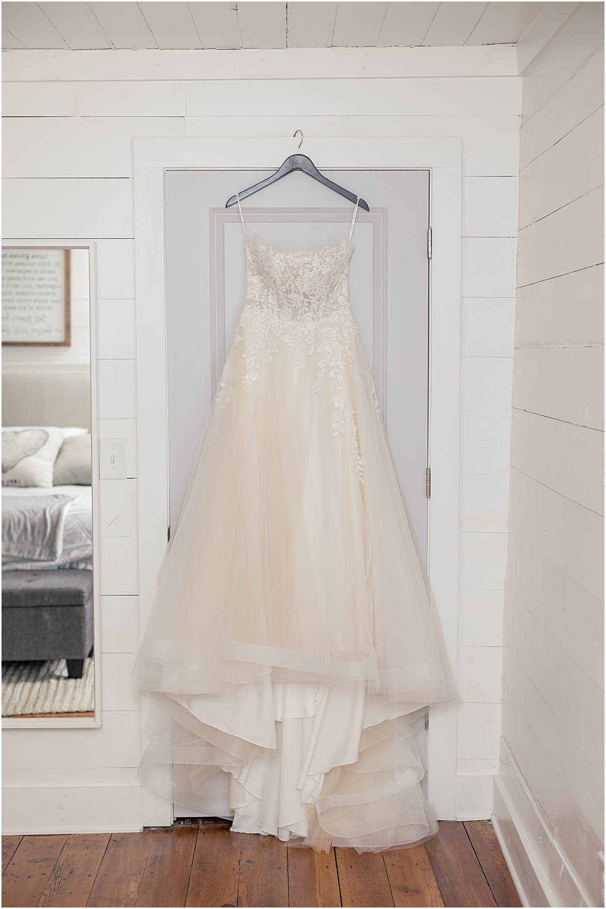 Detail photo of Grace's dress hanging on a doorframe at Cleveland GA Wedding Venues