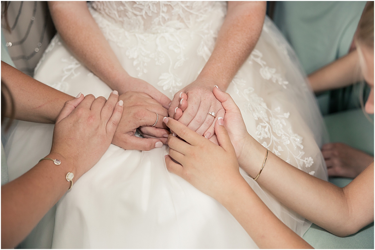 All the bridesmaids holding the brides hands at Cleveland GA Wedding Venues