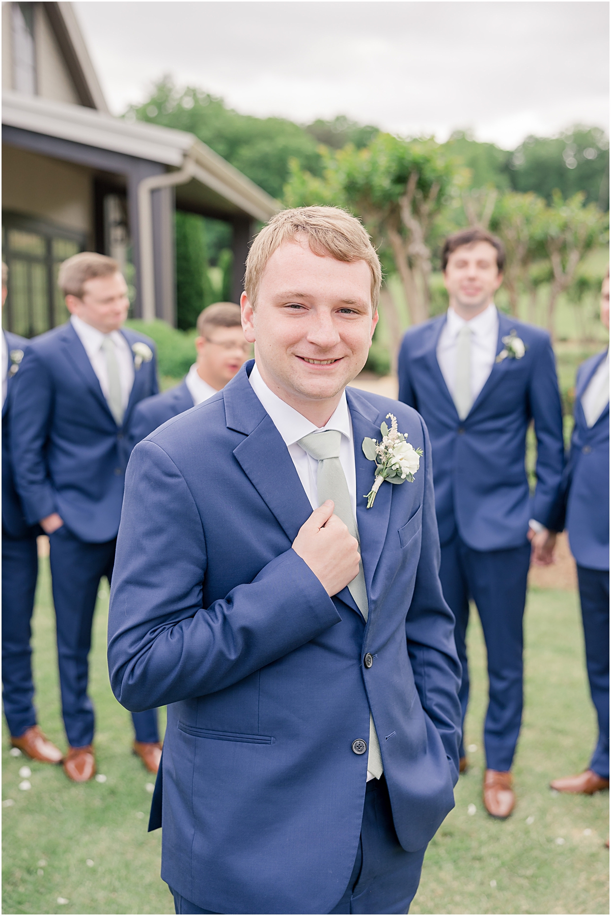 Picture of davis in the foreground with his groomsmen in trhe background at Cleveland GA Wedding Venues