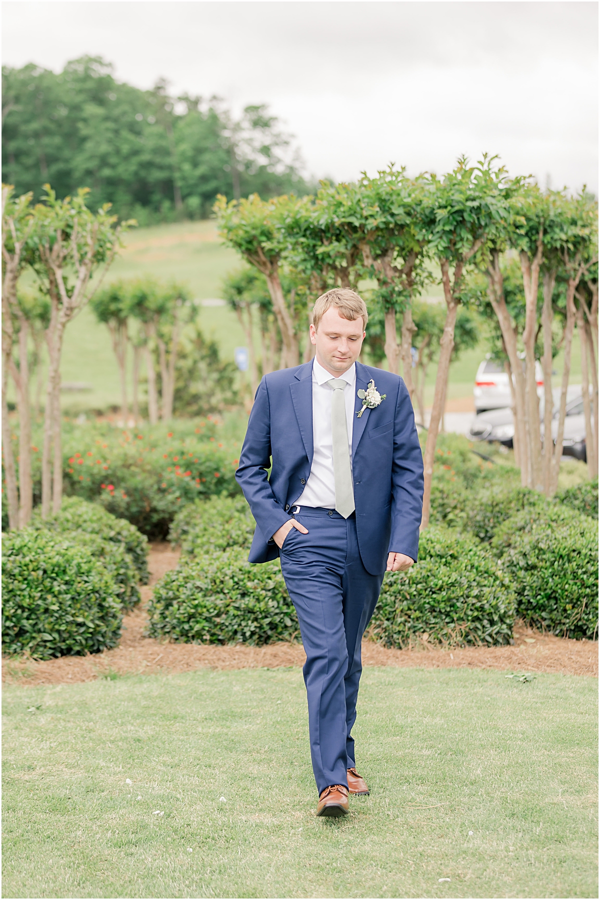 Davis walking in the vineyard with his hand in his pocket at Cleveland GA Wedding Venues