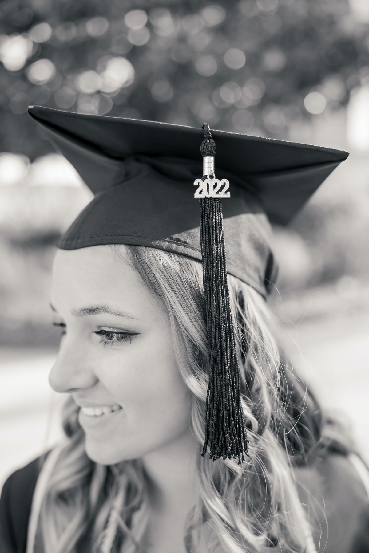 Black and white detail photo of a woman wearing her graduation cap and tassel for University of North Georgia