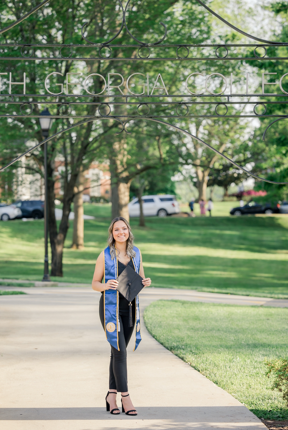 A University of North Georgia graduate walking across campus during her graduation session.