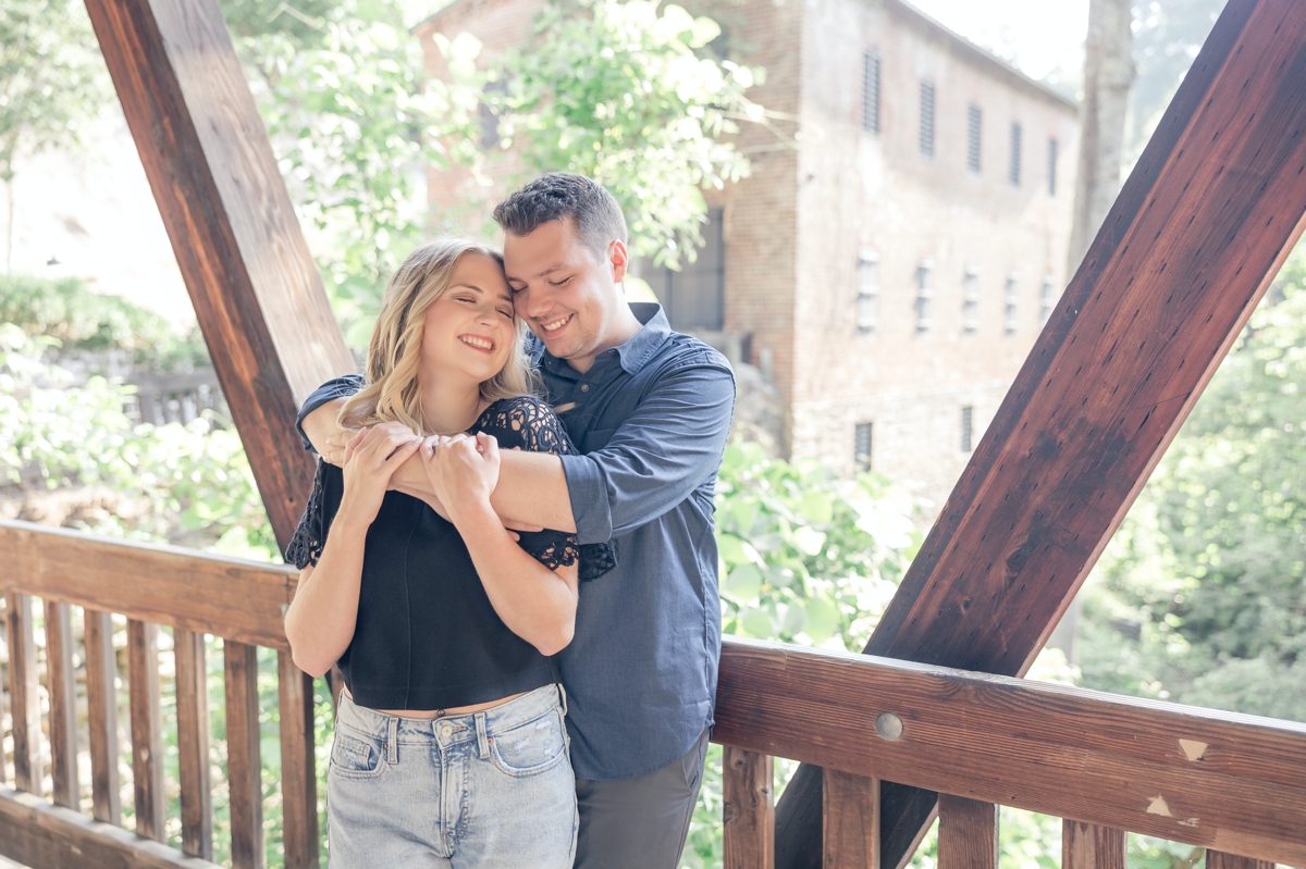 Taylor hugging Julia from behind during their engagement session with Five Fourteen Photography.