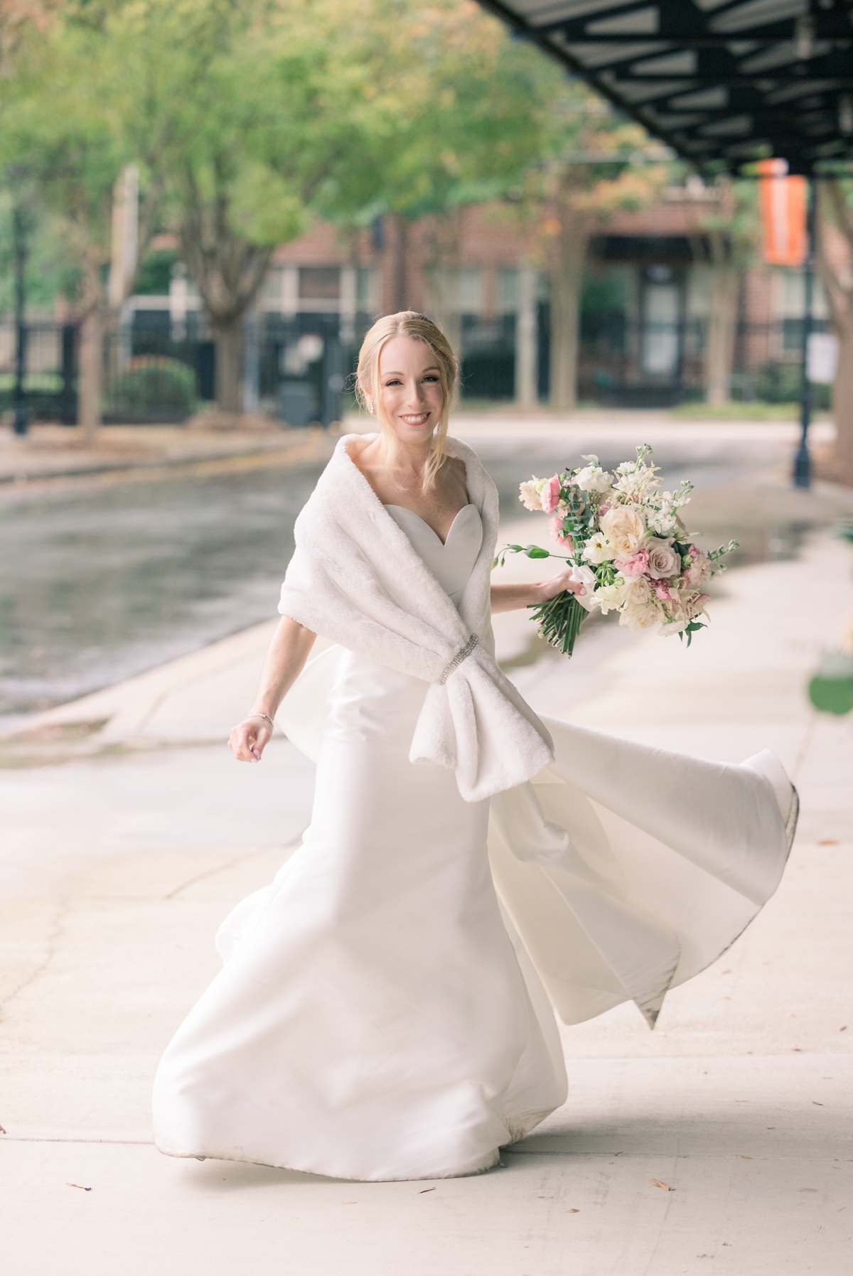 Rebecca spinning in her wedding gown outside Foundry Puritan Mill.