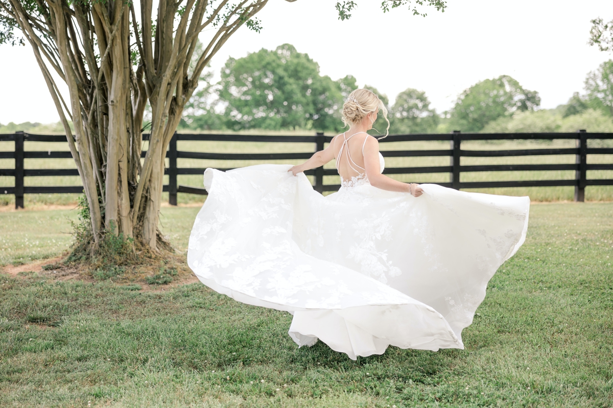 Grace spinning in her wedding dress on the lawn of Walters Barn.