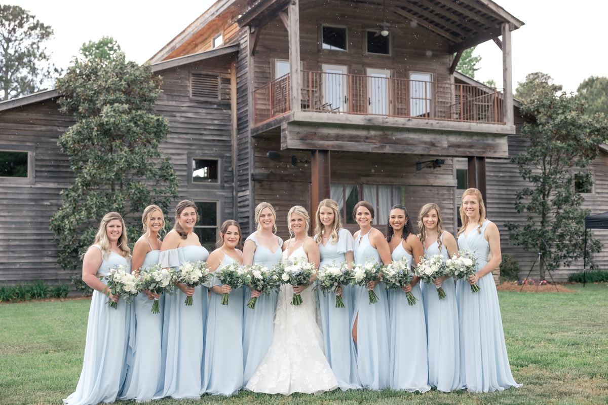Grace and his bridesmaids in their light blue bridesmaids dresses in front of Walters Barn in Lula GA on her wedding day.