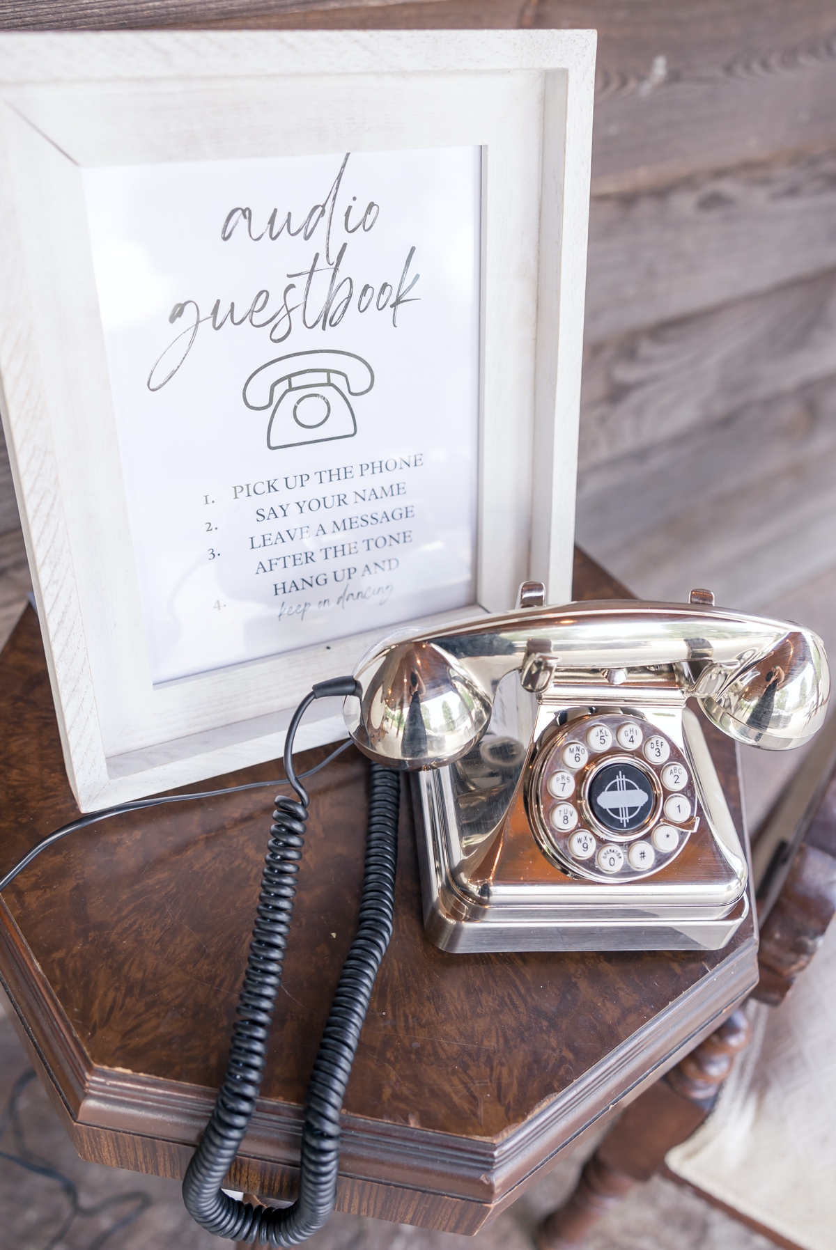 A rotary phone guestbook sitting on a table for Chris and Grace's wedding.