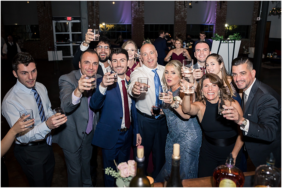 group photo of guests partying during the wedding reception at the foundry at puritan mill wedding venue in georgia