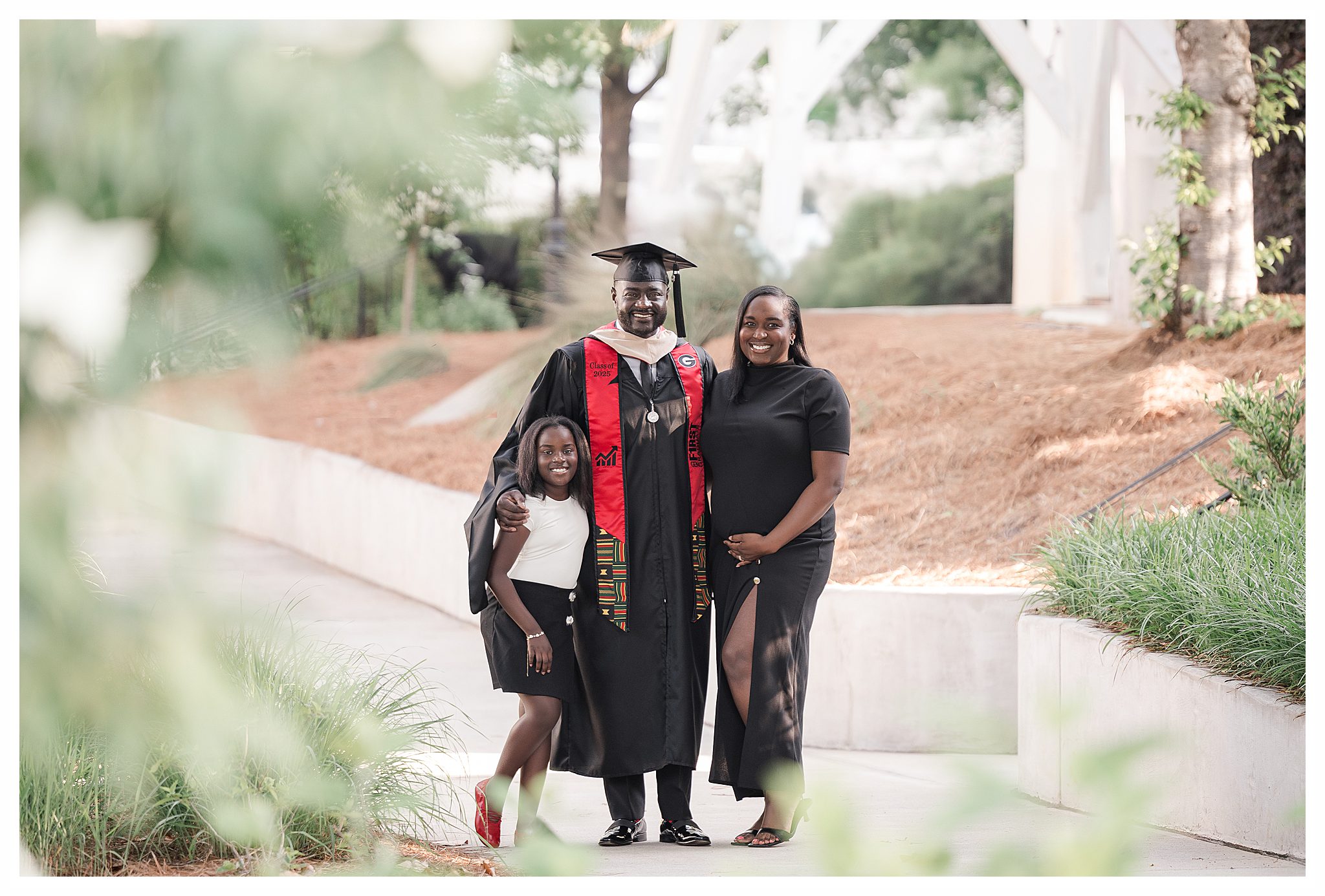 MBA senior photos of the grad at the chapel bell on UGA Campus with family