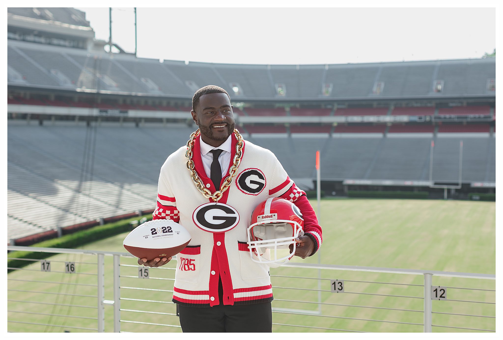 UGA graduate with helmet at Sanford Stadium by the best Athens photographer