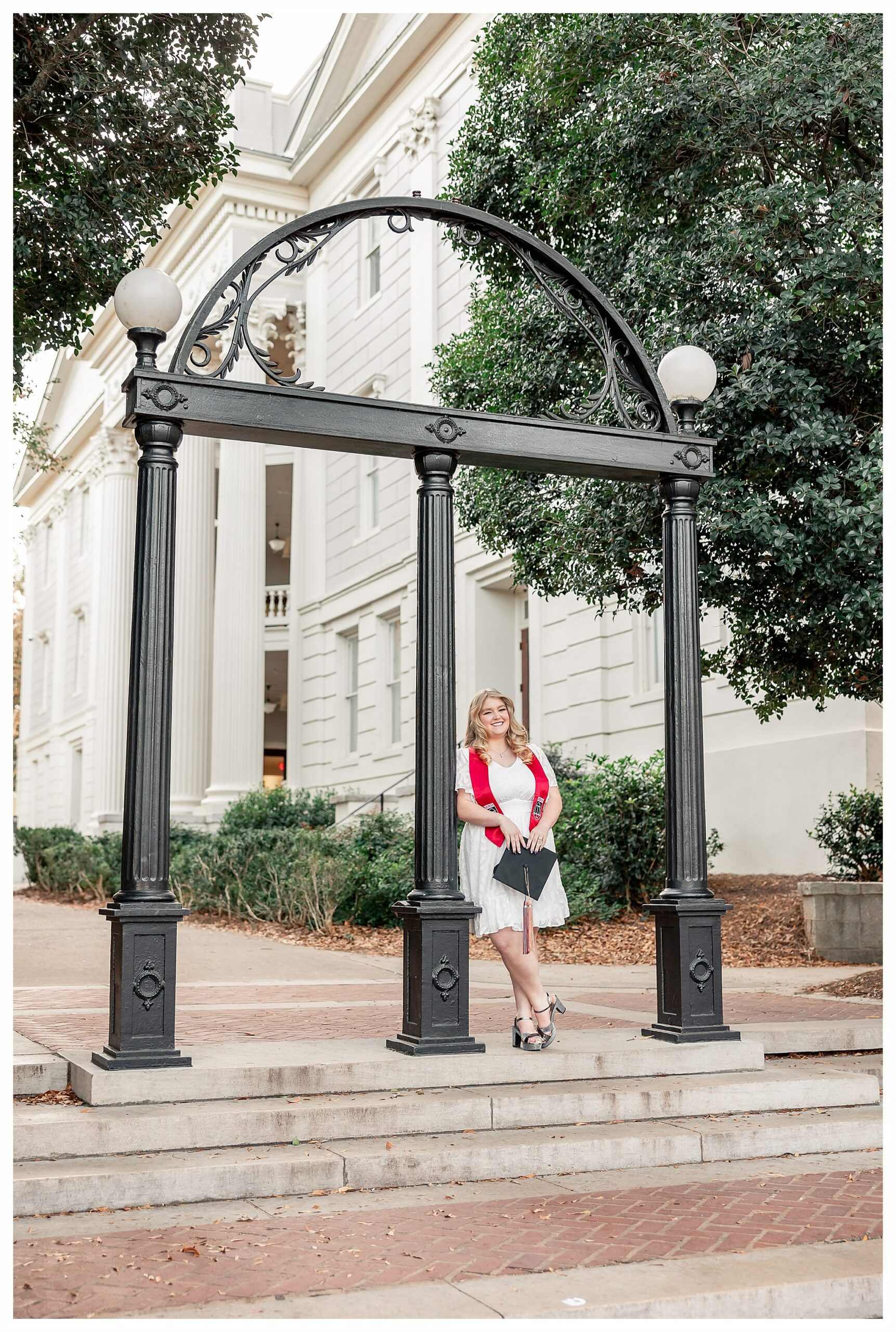 Hannah Page posing at The Arch during her University of Georgia graduation photo session in Athens GA